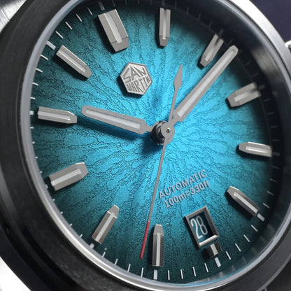 Close-up of San Martin SN0144 Horizon automatic watch with textured blue dial, luminous markers, and 100m water resistance