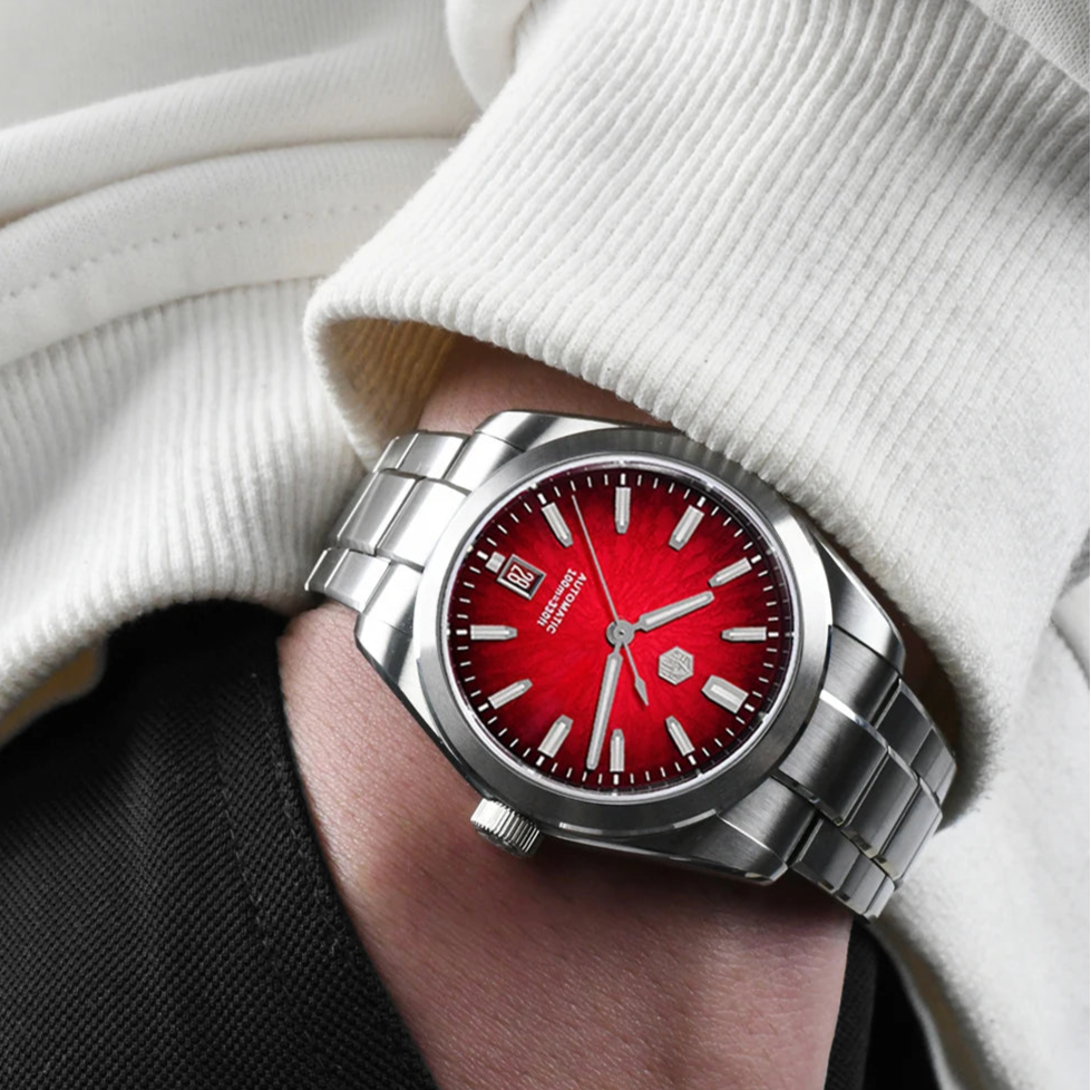  San Martin SN0144 Horizon red dial automatic watch on wrist, highlighting bold color contrast and refined brushed steel bracelet.