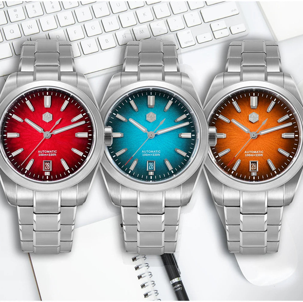 San Martin Horizon SN0144 automatic watches with red, blue, and orange dials displayed on a desk, representing the full vibrant collection