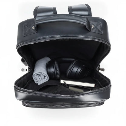 Black Genuine Leather Laptop Backpack — open main compartment with headphones, cloth and notebook
