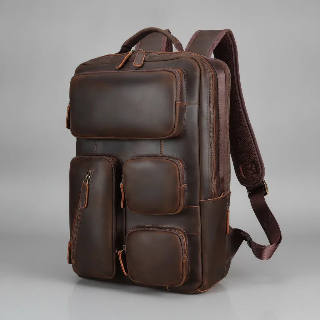 Vintage Leather Laptop Backpack — three-quarter front view on a grey background