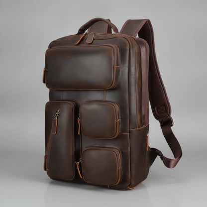 Vintage Leather Laptop Backpack — three-quarter front view on a grey background